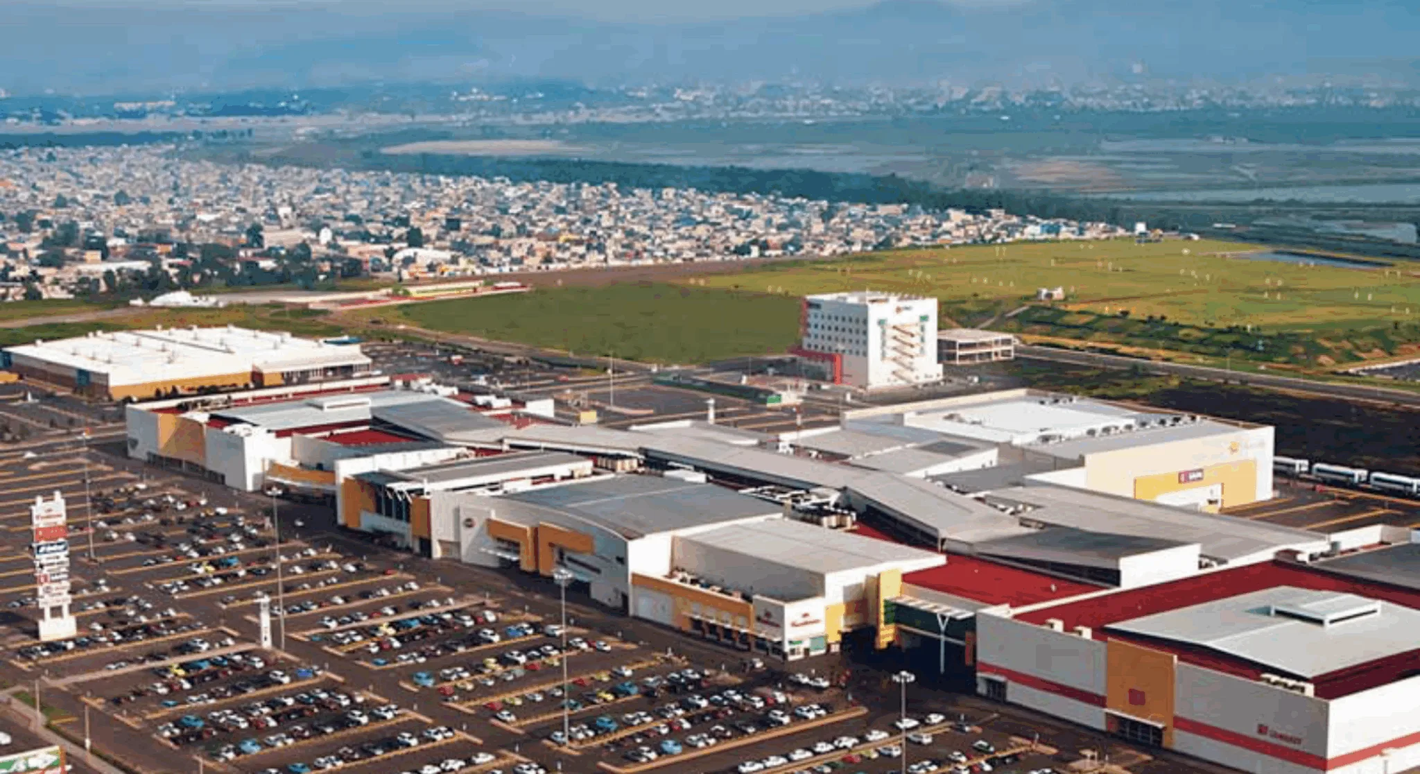 Aerial view of a large commercial complex and parking area